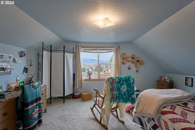 bedroom featuring light carpet, a mountain view, a textured ceiling, and vaulted ceiling