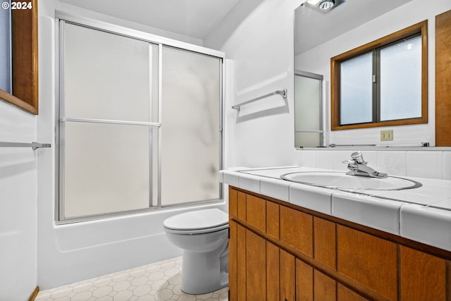 full bathroom with toilet, vanity, and combined bath / shower with glass door