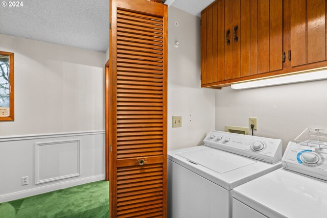 washroom featuring washer and dryer, carpet, cabinets, and a textured ceiling