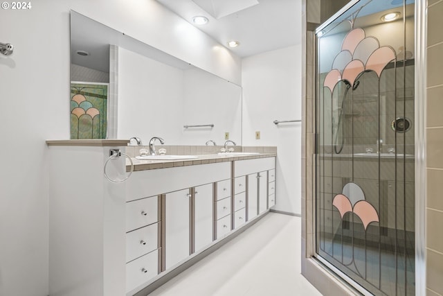 bathroom with vanity and a shower with shower door