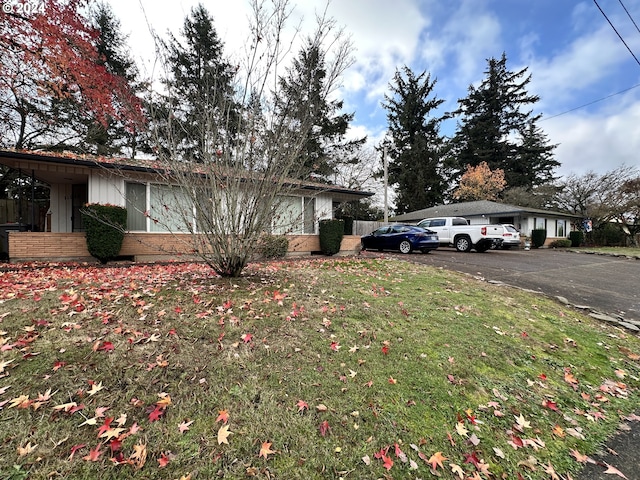 view of side of home featuring a lawn