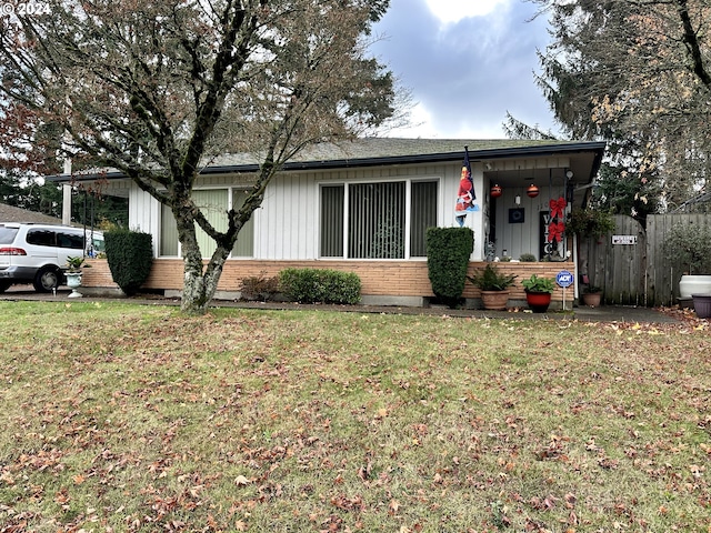 ranch-style home with a front lawn