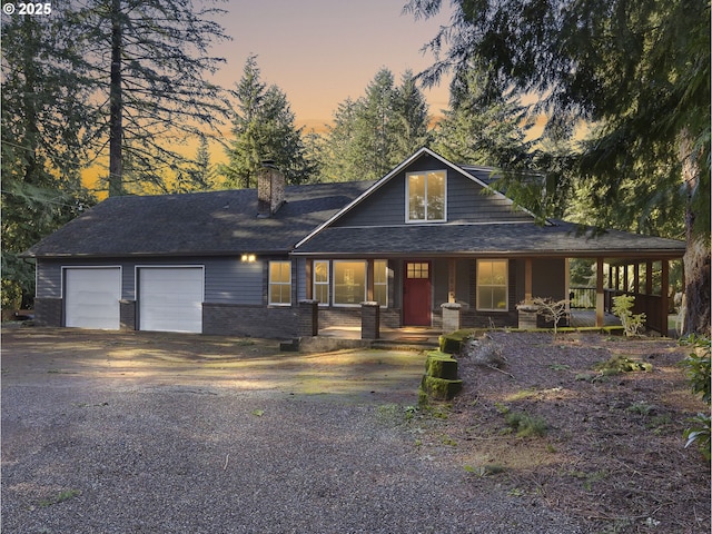 view of front facade featuring a porch and a garage