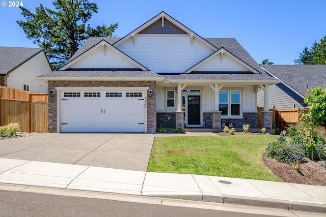 craftsman-style home featuring a garage, a porch, and a front lawn