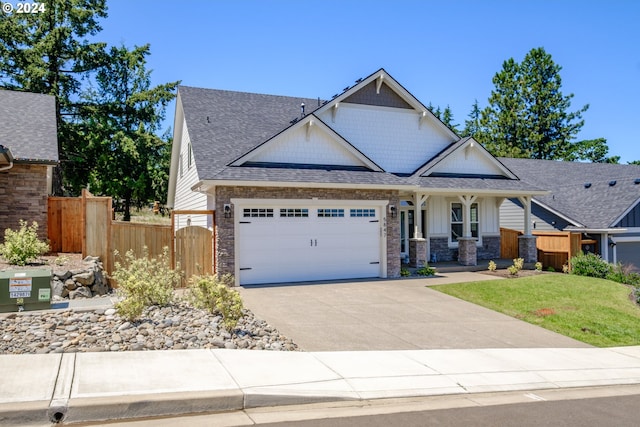 craftsman-style home featuring a garage and a front yard