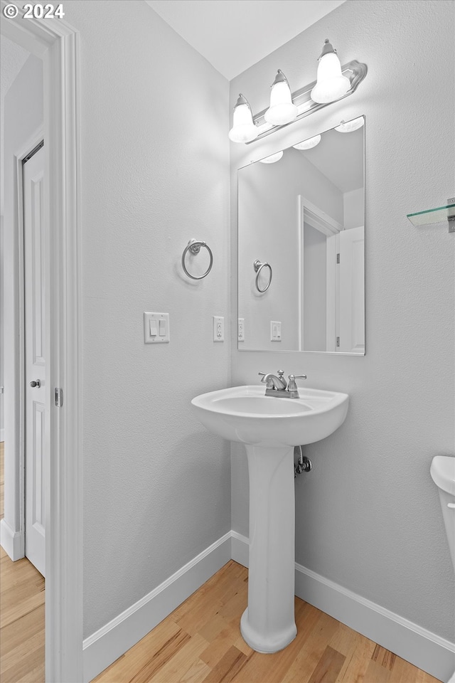 bathroom with hardwood / wood-style flooring