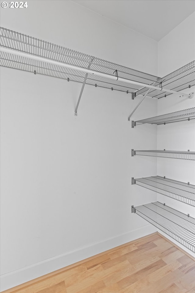 walk in closet featuring hardwood / wood-style flooring