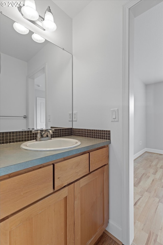 bathroom with hardwood / wood-style floors and vanity