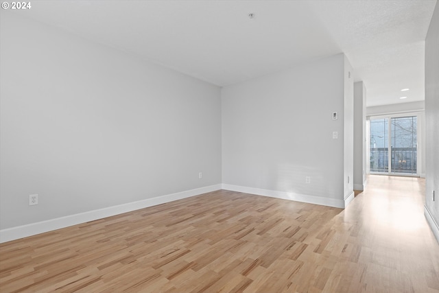 unfurnished room with light hardwood / wood-style flooring