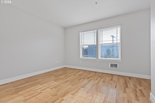 spare room with light wood-type flooring