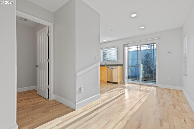 empty room with sink and light hardwood / wood-style flooring