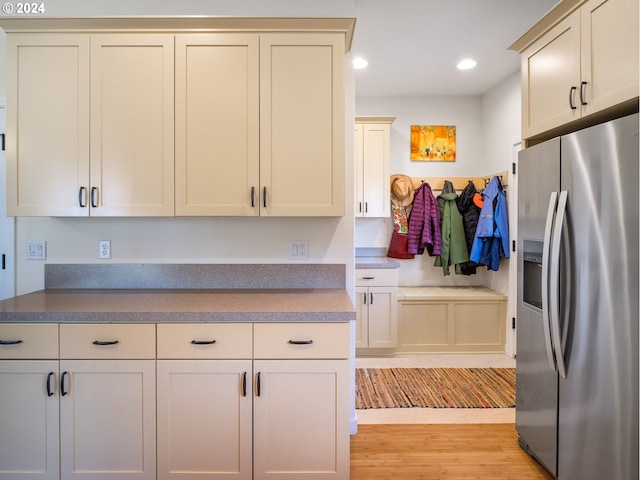 kitchen featuring stainless steel refrigerator with ice dispenser and light wood-type flooring