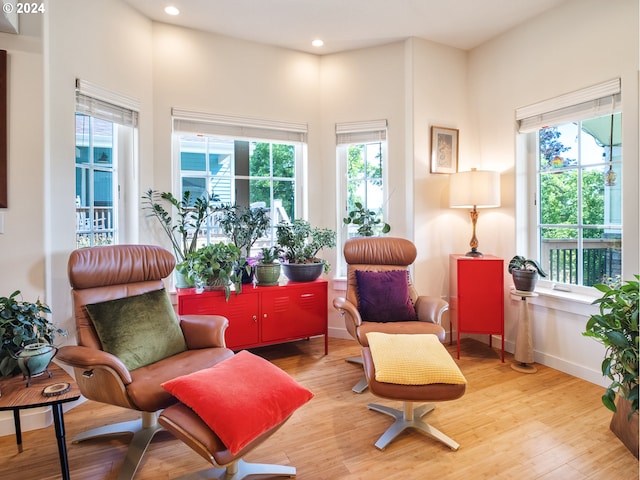 living area with plenty of natural light and light hardwood / wood-style floors