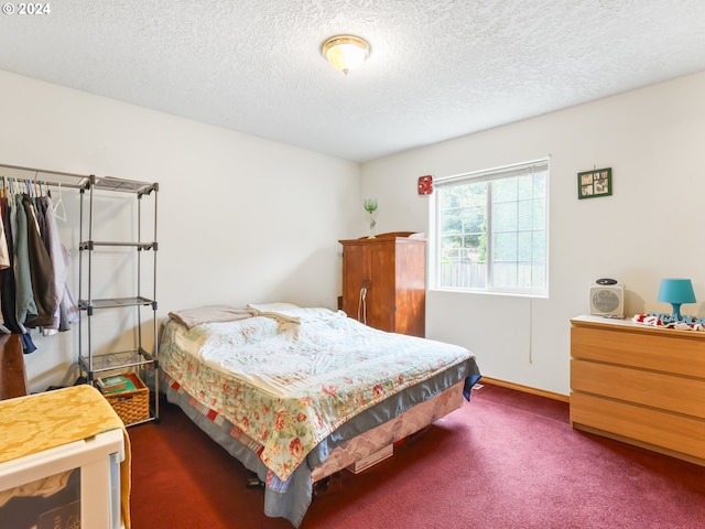 carpeted bedroom featuring a textured ceiling