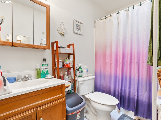 bathroom featuring a shower with curtain, vanity, and toilet