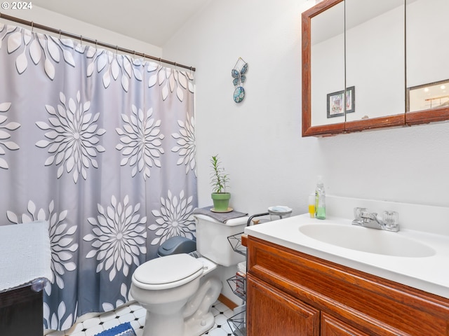 bathroom with vanity, tile patterned flooring, toilet, and curtained shower