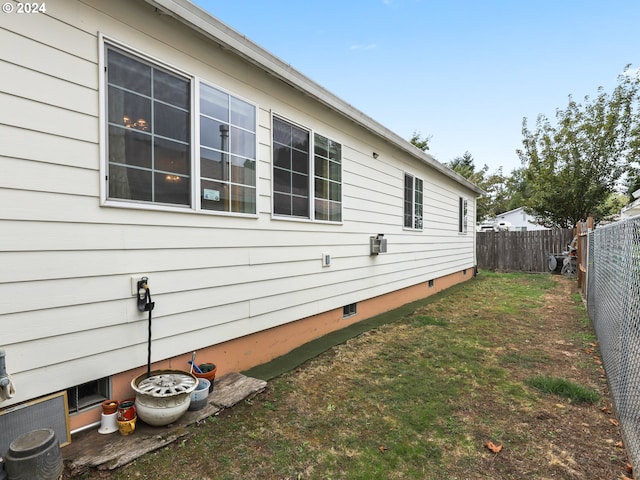 view of side of home featuring a yard