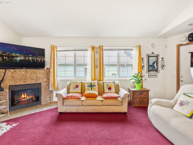 carpeted living room featuring lofted ceiling and a tiled fireplace