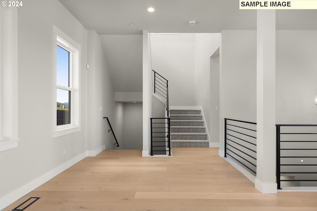 stairs featuring wood-type flooring