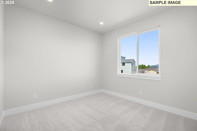 unfurnished room with light colored carpet