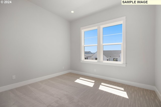 empty room featuring light colored carpet