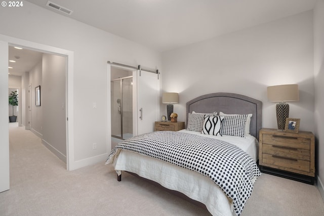 carpeted bedroom featuring a barn door