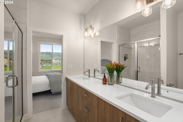 bathroom featuring tile patterned flooring, vanity, and a shower with door