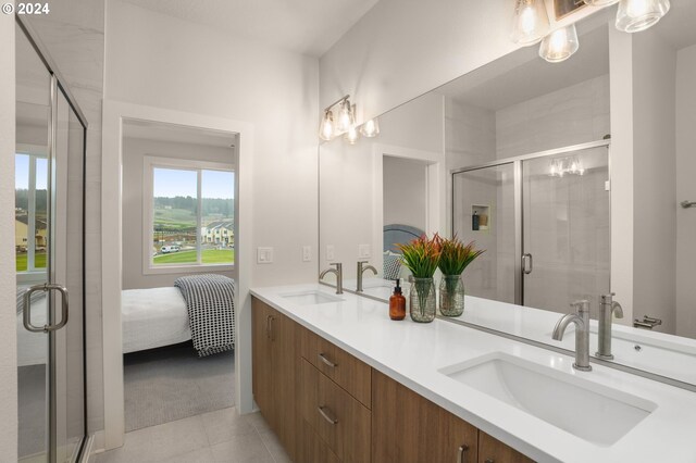 ensuite bathroom featuring a sink, a shower stall, ensuite bath, and double vanity