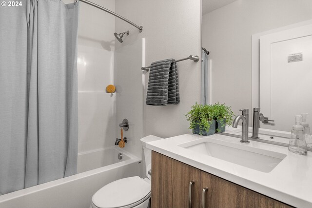 full bathroom with vanity, toilet, and shower / bath combo with shower curtain