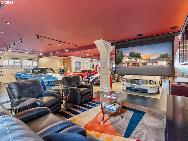 home theater with a textured ceiling and ornate columns