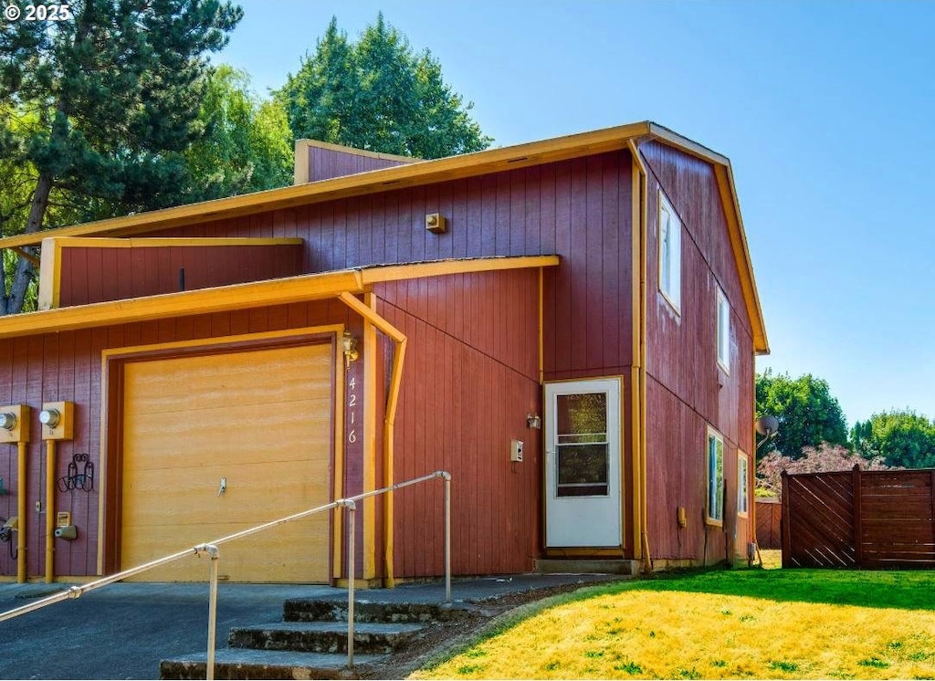 view of front of property with a garage and a front lawn