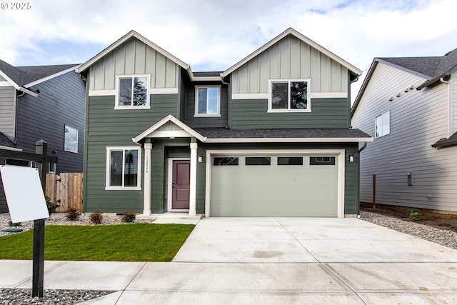 view of front of home featuring board and batten siding, fence, driveway, and an attached garage