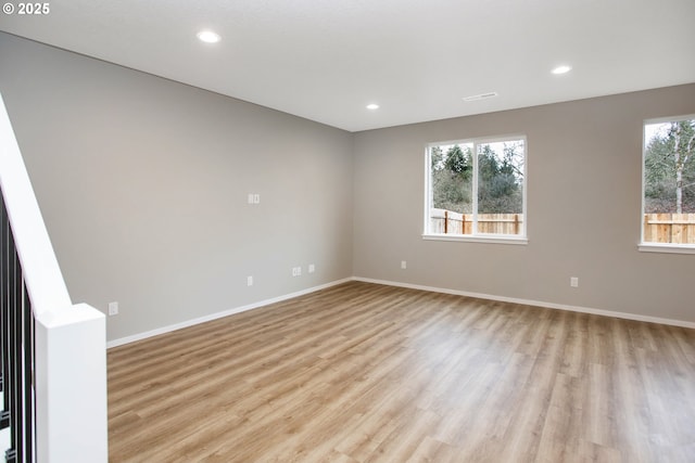 unfurnished room featuring baseboards, light wood-type flooring, and recessed lighting