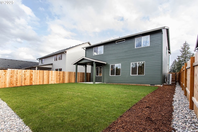 back of house featuring a fenced backyard, a yard, and a patio