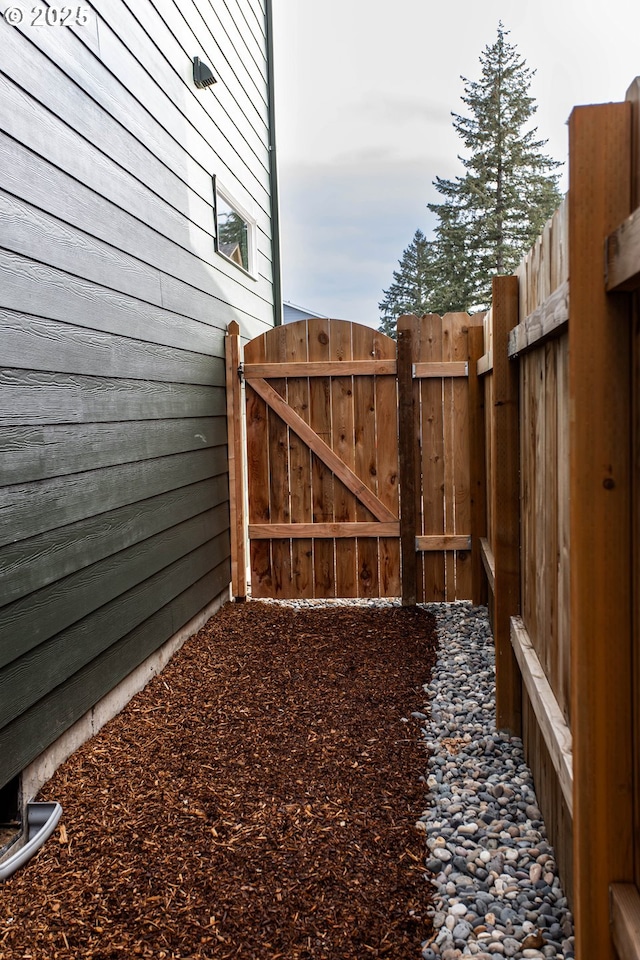 view of yard with fence and a gate