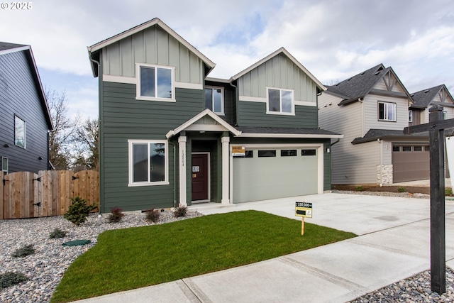 view of front of property featuring an attached garage, board and batten siding, a front yard, fence, and driveway