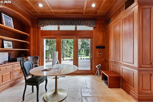 dining room with wood ceiling, ornamental molding, and wooden walls