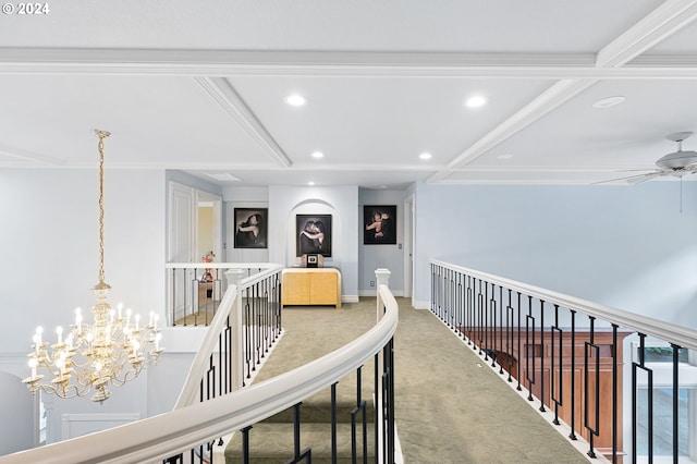 hallway featuring carpet flooring, a chandelier, and crown molding