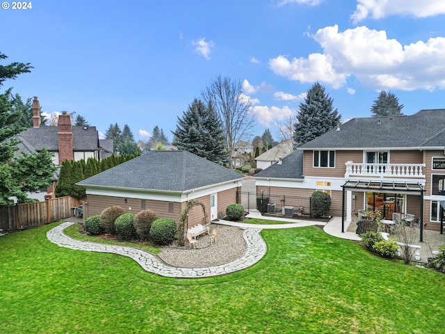 view of yard with a patio, a balcony, and central AC