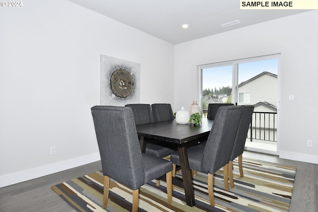 dining area featuring dark wood-type flooring