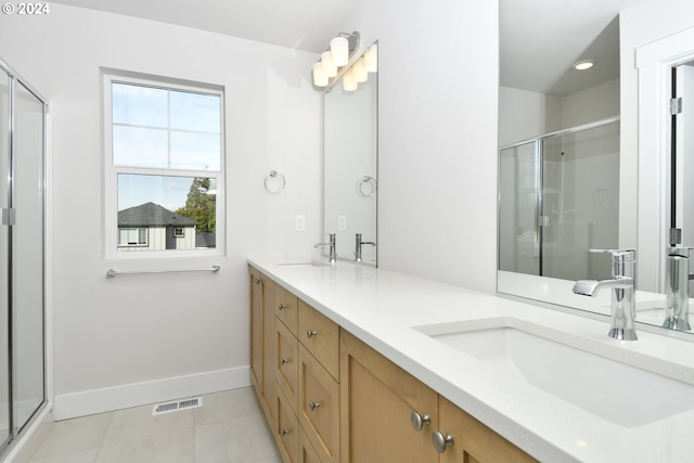 bathroom featuring vanity, tile patterned floors, and an enclosed shower