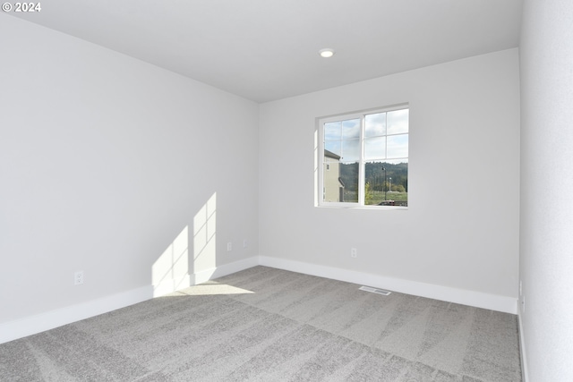 spare room with light colored carpet