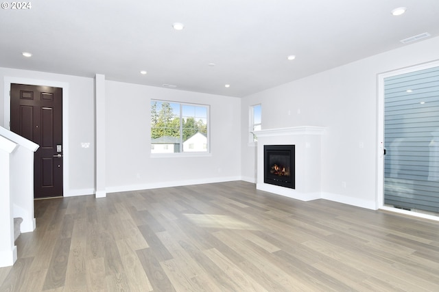 unfurnished living room with light hardwood / wood-style floors