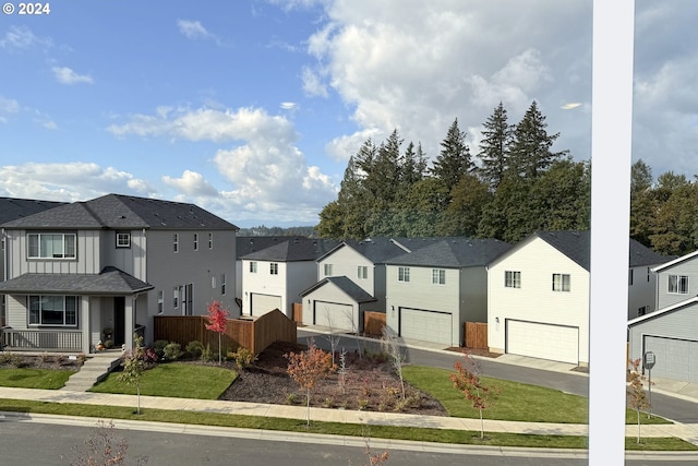 view of front facade with a front yard and a garage