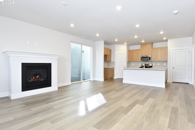 unfurnished living room with light hardwood / wood-style flooring