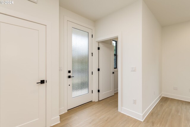 corridor with light wood-type flooring