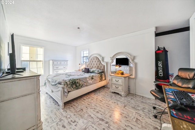 bedroom featuring light wood-type flooring and ornamental molding