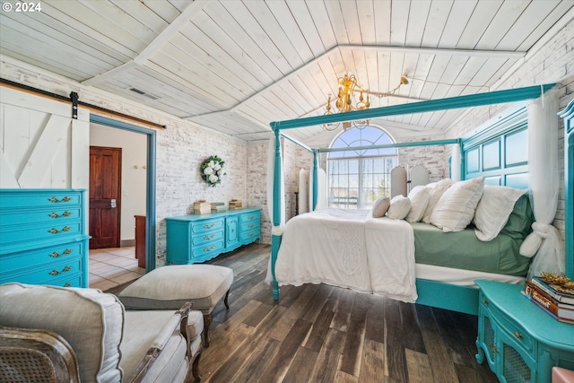 bedroom with wood ceiling, a barn door, dark hardwood / wood-style flooring, and brick wall