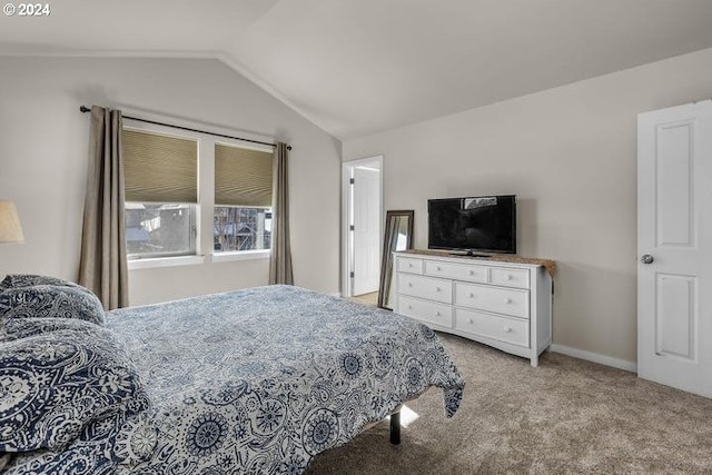 bedroom featuring light colored carpet and lofted ceiling