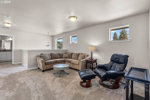 living room with plenty of natural light and light colored carpet